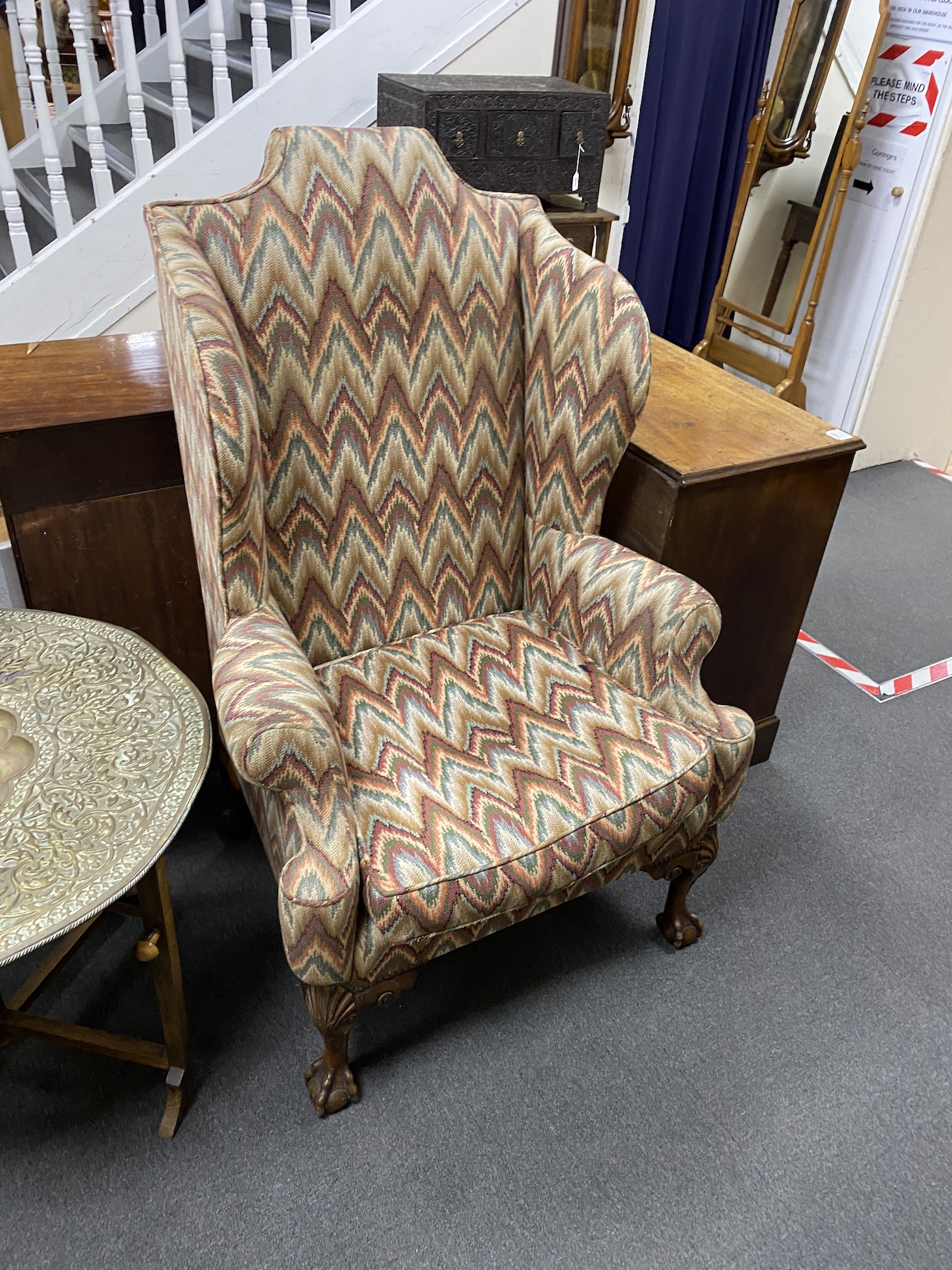 A pair of George III style upholstered wingback armchairs, width 84cm, depth 70cm, height 130cm
